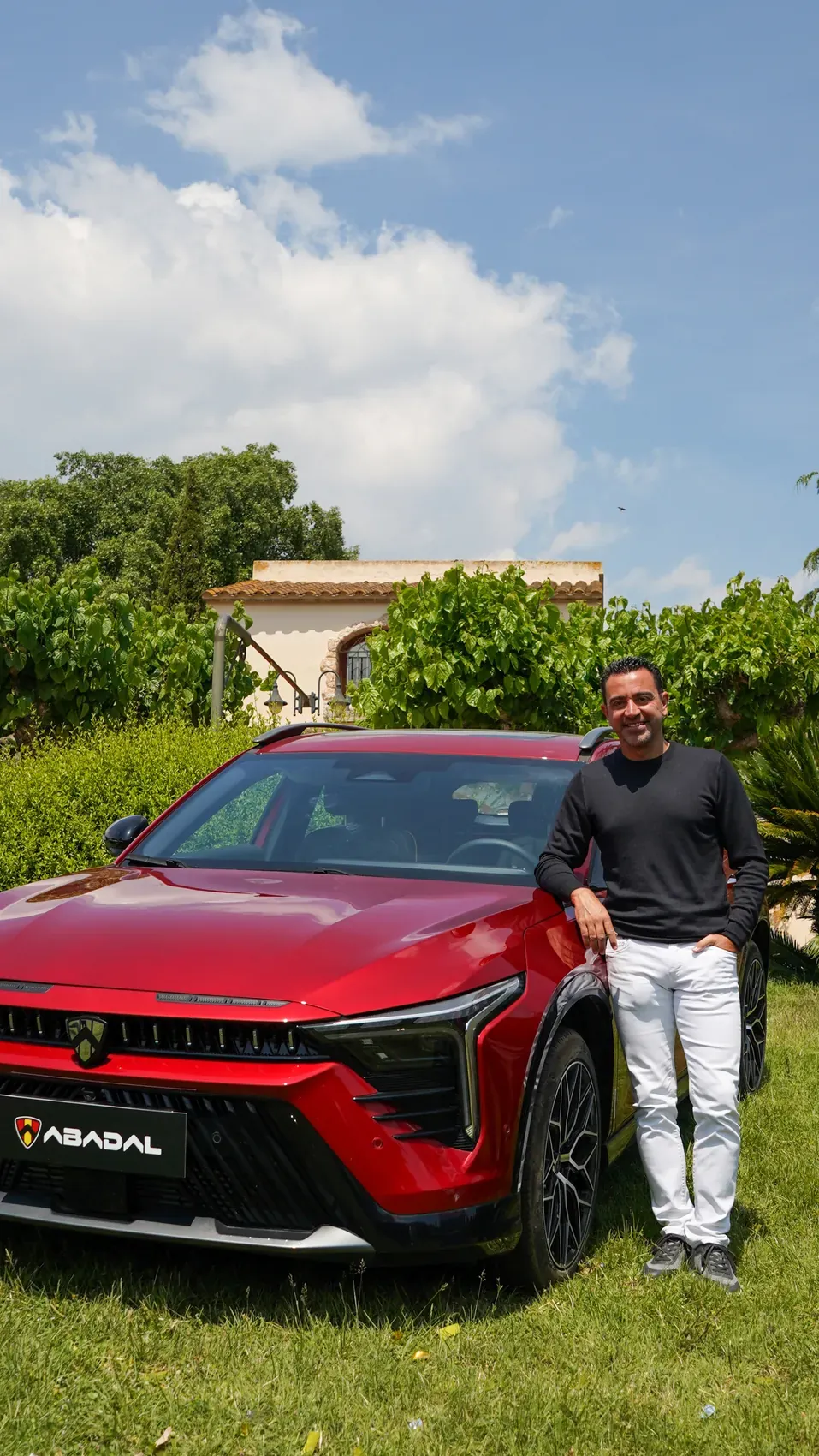 Xavi Hernández next to the red ABADAL NOVO